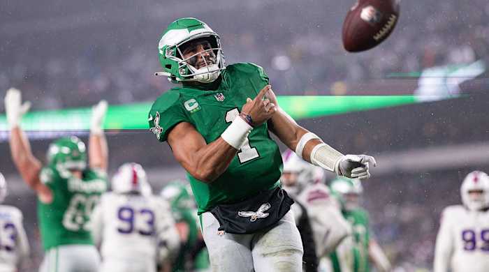 Jalen Hurts flings the football after scoring a touchdown
